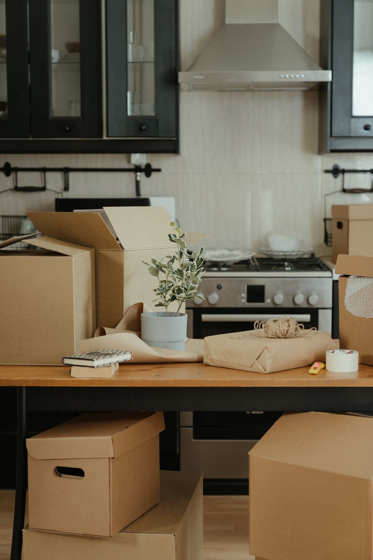 Kitchen with organized moving boxes and packing materials ready for a move