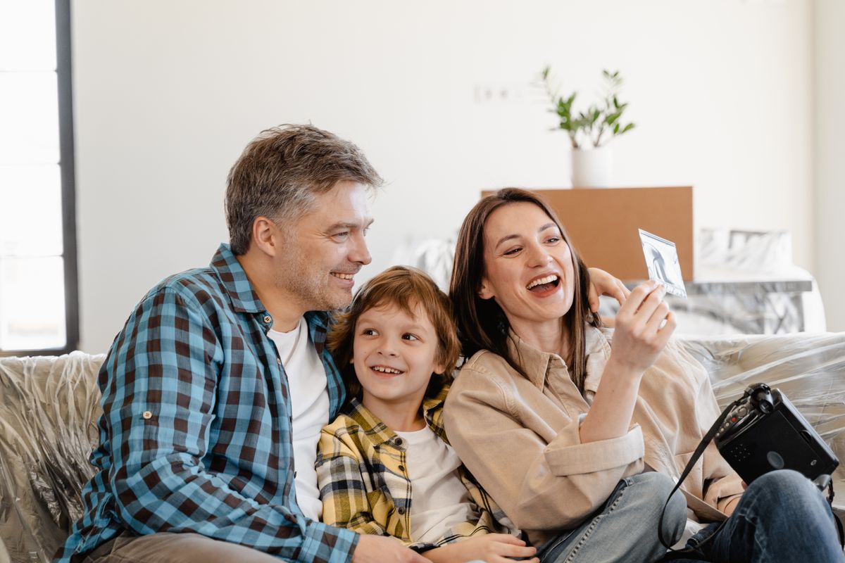 Family surrounded by moving boxes in their new home